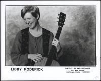 Libby Roderick with sweater, vest, and guitar