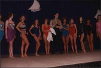 Ten women and one male Stevens models look to their left as they stand in a line during the Boat Show Fashion Show