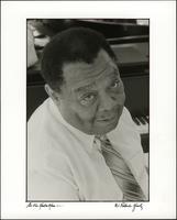 Jay McShann looking up from his piano