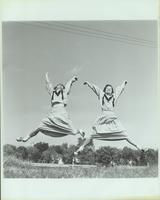 Two female Mizzou cheerleaders jumping