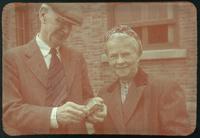 Hiller 09-084: A couple standing in front of a brick house in Nanking 2