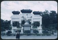 Hiller 08-054: Girl posed in front of a white, decorative monument