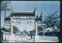 Hiller 08-092: Ornate gateway over a street, Peiping