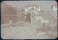 Hiller 07-099 e: Shack seperated from other, white homes, Chapel