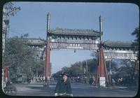 Hiller 08-015: Decorative archway over a busy street, Peiping