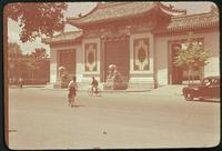 Hiller 08-058: People riding bikes in front of a white building, Peiping