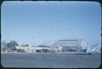 Hiller 08-005: Open field with military planes, structures, and people, Tianjin, China 