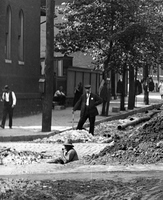 Workers Installing Pipe In Street