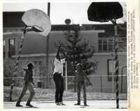 Children play basketball at Laclede Town (Village) Apartments