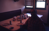 Worker Seated at Dining Table in Towboat