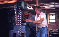 Workers Adjusting Equipment in Towboat Engine Room