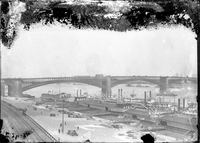 Photograph of Several Steamboats and Bridge