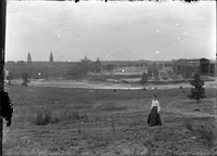 Photograph of Woman Standing in Front of World Fair Construction